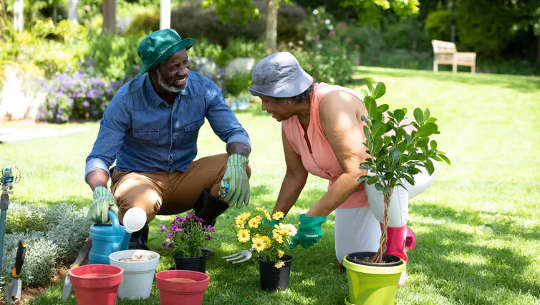 two people chatting and gardening