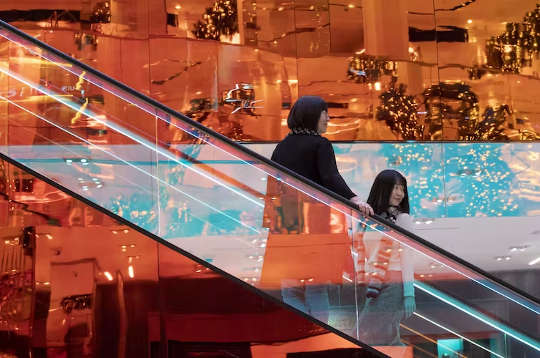 store shoppers on an escalator