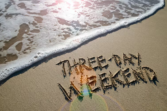 a beach with the words "3-day weekend" written in the sand