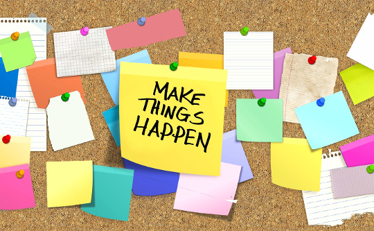 bulletin board with a post it note with big letters: MAKE THINGS HAPPEN