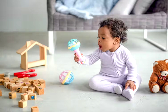 a baby sitting on the floor playing with toys
